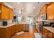 Open kitchen and dining room featuring wood cabinets, granite countertops, stainless steel appliances, and backyard access at 5849 Mcclintock Dr # 117, Denver, NC 28037