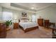 Main bedroom with a tray ceiling, carpet, and coordinated furniture at 5849 Mcclintock Dr # 117, Denver, NC 28037