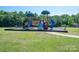 Community playground featuring multiple slides and play structures in a landscaped green space at 5849 Mcclintock Dr # 117, Denver, NC 28037