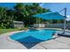 A sparkling in-ground pool with a waterfall feature and umbrella for shade at 5849 Mcclintock Dr # 117, Denver, NC 28037
