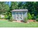 Backyard shed for storing tools and equipment surrounded by lush green landscaping at 5849 Mcclintock Dr # 117, Denver, NC 28037