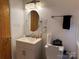 Bright bathroom featuring a modern vanity, updated fixtures, and an oval mirror at 703 S Highway 27 Hwy, Stanley, NC 28164