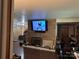 Cozy living room with wood paneling, fireplace, mounted television, and comfortable leather seating and hardwood floors at 703 S Highway 27 Hwy, Stanley, NC 28164
