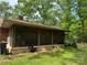 Enclosed screened porch with fan and brick foundation, perfect for enjoying the outdoors comfortably at 703 S Highway 27 Hwy, Stanley, NC 28164