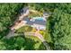 Expansive estate with lush landscaping, mature trees, sparkling pool, a detached guest house, and a circular driveway at 707 Saint Cloud Dr, Statesville, NC 28625