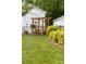 Landscaped backyard featuring a wooden swing set and lush, green lawn at 707 Saint Cloud Dr, Statesville, NC 28625