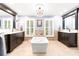Elegant bathroom with a standalone tub, dual vanities, chandelier, and shuttered windows at 707 Saint Cloud Dr, Statesville, NC 28625