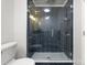 Modern bathroom featuring a tiled shower with glass door and tiled walls at 707 Saint Cloud Dr, Statesville, NC 28625