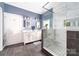 Modern bathroom with a double vanity, walk-in shower with tile surround, and neutral color palette at 707 Saint Cloud Dr, Statesville, NC 28625