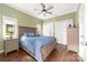 Comfortable bedroom features hardwood floors, a ceiling fan, and ample natural light from a window at 707 Saint Cloud Dr, Statesville, NC 28625