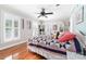 Bright bedroom with hardwood floors, white trim, a ceiling fan, and natural light at 707 Saint Cloud Dr, Statesville, NC 28625
