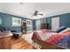 Comfortable bedroom with hardwood floors, a ceiling fan, and neutral walls at 707 Saint Cloud Dr, Statesville, NC 28625
