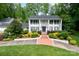 Elegant white home featuring stately columns, a second-story balcony, and professionally landscaped front yard at 707 Saint Cloud Dr, Statesville, NC 28625