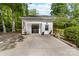 Detached garage with black doors and a concrete driveway offers ample parking at 707 Saint Cloud Dr, Statesville, NC 28625