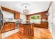 A spacious eat-in kitchen features custom wood cabinets, granite counters, and a center island with a vegetable sink at 707 Saint Cloud Dr, Statesville, NC 28625