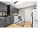 Functional laundry room featuring gray cabinetry, modern appliances, and ample storage space at 707 Saint Cloud Dr, Statesville, NC 28625