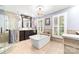 This main bathroom features double vanity sinks, soaking tub, walk-in shower and travertine floors at 707 Saint Cloud Dr, Statesville, NC 28625