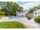 Gorgeous backyard oasis with a uniquely shaped pool, jacuzzi, outdoor seating, and a covered bar area at 707 Saint Cloud Dr, Statesville, NC 28625