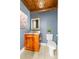 A quaint powder room features custom wood cabinets and a crystal chandelier at 707 Saint Cloud Dr, Statesville, NC 28625