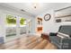 Cozy sunroom with wood floors, a comfortable chair, and access to a patio with stairs at 707 Saint Cloud Dr, Statesville, NC 28625