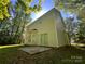 Spacious backyard with lush greenery, a concrete patio, and shade trees providing outdoor enjoyment at 716 Coy Ct, Charlotte, NC 28216