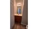 Comfortable half bathroom featuring vanity, mirror, and wooden floors at 716 Coy Ct, Charlotte, NC 28216