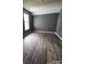 Spacious bedroom featuring new hardwood floors, freshly painted walls and lots of natural light from the window at 716 Coy Ct, Charlotte, NC 28216