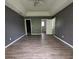 Large bedroom suite featuring ceiling fan, hardwood floors and gray walls at 716 Coy Ct, Charlotte, NC 28216