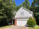 Two-story home featuring a brick and siding exterior, with attached two car garage at 716 Coy Ct, Charlotte, NC 28216