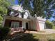 Charming two-story home featuring brick accents, white siding, and a well-manicured front yard at 716 Coy Ct, Charlotte, NC 28216