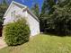 Well-maintained home exterior with lush greenery and mature trees in a serene setting at 716 Coy Ct, Charlotte, NC 28216