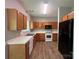 Functional kitchen with laminate countertops, wood cabinets, and modern appliances at 716 Coy Ct, Charlotte, NC 28216