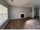 Open living room with wood floors, fireplace and natural light, great for relaxation and gatherings at 716 Coy Ct, Charlotte, NC 28216