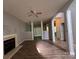 Open-concept living room featuring a fireplace, wood floors, and a ceiling fan for comfortable living at 716 Coy Ct, Charlotte, NC 28216