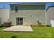 A fenced backyard with a concrete patio and sliding glass door to the house at 7311 Fig Ln, Charlotte, NC 28215