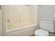 Bathroom features a white toilet and bathtub with a showerhead and sleek fixtures at 7311 Fig Ln, Charlotte, NC 28215