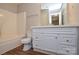 Bright bathroom with white vanity, framed mirror, and a shower-tub combination with modern fixtures at 7311 Fig Ln, Charlotte, NC 28215