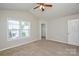 Bedroom with carpet, ceiling fan, and a view from the windows at 7311 Fig Ln, Charlotte, NC 28215