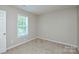 Bedroom with carpeted floor, neutral paint, and window letting in natural light at 7311 Fig Ln, Charlotte, NC 28215