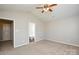 Bedroom featuring carpet, neutral walls, and ensuite bathroom entrance at 7311 Fig Ln, Charlotte, NC 28215