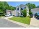 Traditional home featuring a well-maintained lawn, attached garage, and classic design elements at 7311 Fig Ln, Charlotte, NC 28215