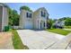 Inviting two-story home with a spacious driveway, an attached garage, and tidy front yard landscaping at 7311 Fig Ln, Charlotte, NC 28215