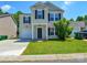 Charming two-story home with a well-manicured lawn and attached garage and crisp contrasting shutters at 7311 Fig Ln, Charlotte, NC 28215