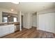 Kitchen with stainless steel appliances, wooden floors, and white cabinets at 7311 Fig Ln, Charlotte, NC 28215