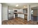 Kitchen featuring stainless steel appliances, white cabinetry and modern flooring at 7311 Fig Ln, Charlotte, NC 28215