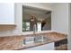 Bright kitchen showcasing an open layout with sink view to the living room at 7311 Fig Ln, Charlotte, NC 28215