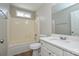 Clean bathroom featuring a tub/shower combination, white vanity, and ample natural light at 7711 Brisbane Ct, Charlotte, NC 28215