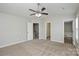 Neutral bedroom with a ceiling fan, carpet, multiple entryways, and closet at 7711 Brisbane Ct, Charlotte, NC 28215