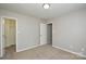 Bedroom with carpeted flooring, closet, and neutral paint scheme at 7711 Brisbane Ct, Charlotte, NC 28215