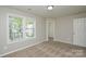 Bright bedroom featuring neutral paint, plush carpet, and natural light from double windows at 7711 Brisbane Ct, Charlotte, NC 28215